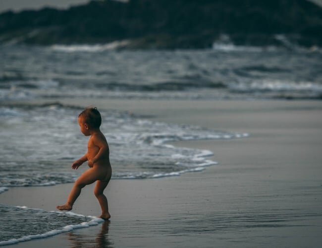naked baby at beach